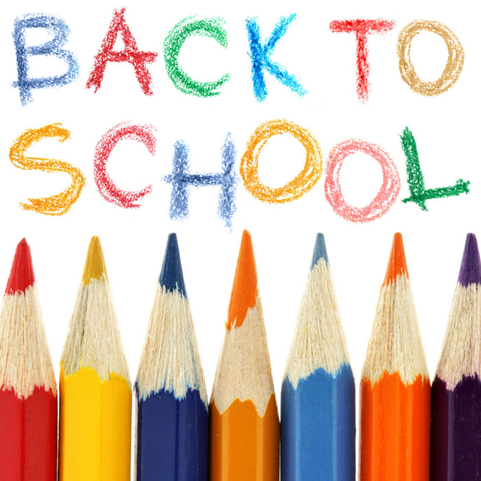 Crayons and back to school text over white background